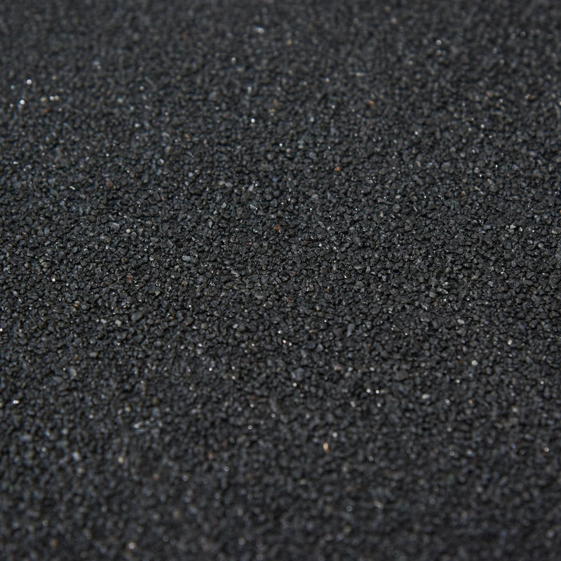 Close-up of the dark asphalt granules on the shed roof covering