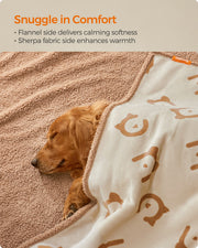 Close-up of a dog snuggled in the reversible sherpa and flannel sides of the blanket
