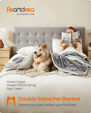 Lifestyle shot of the Feandrea double-sided pet blanket draped on a sofa with a dog