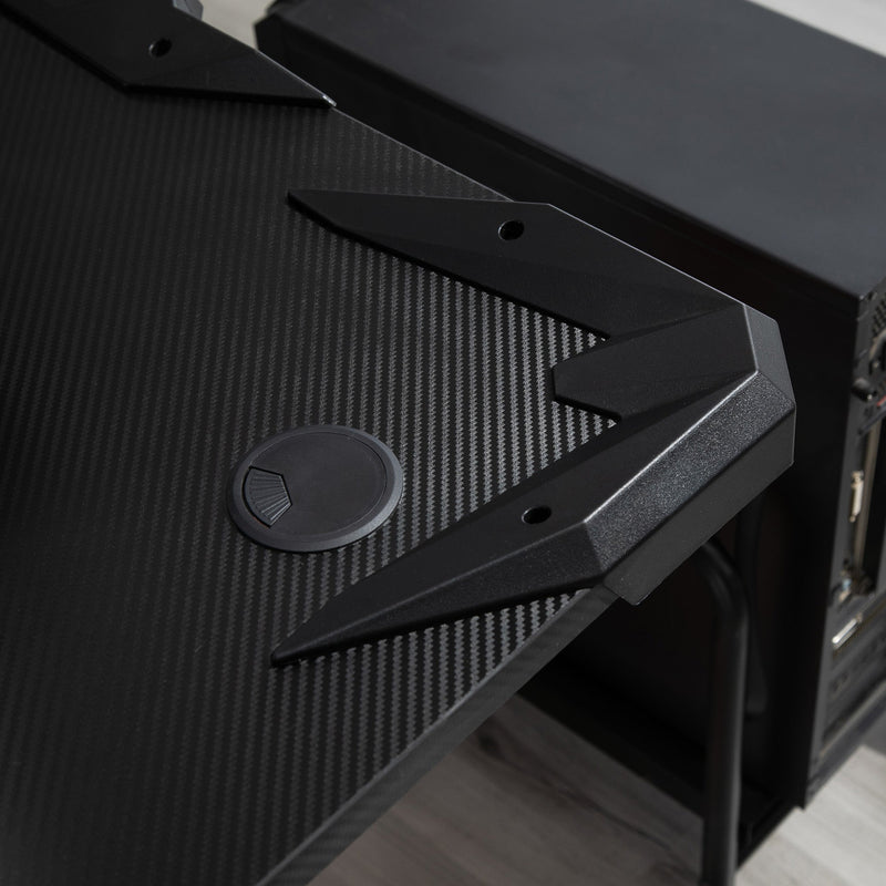 Close-up of the tabletop corner with a cable hole cover and a PC tower alongside