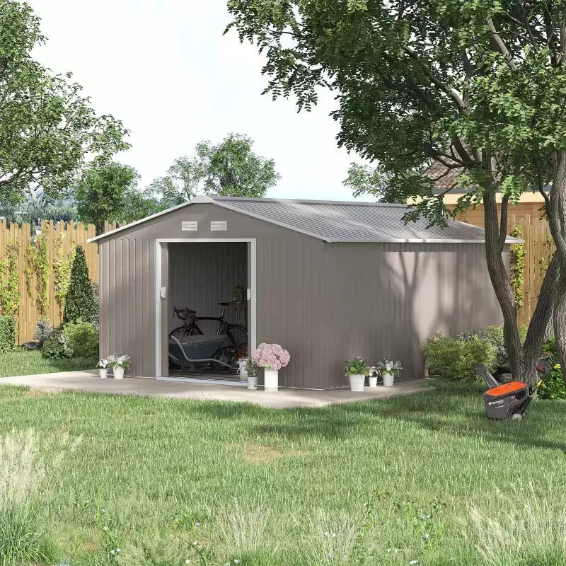 Light grey 13x11ft metal shed on a lawn with the sliding doors open and a mower outside