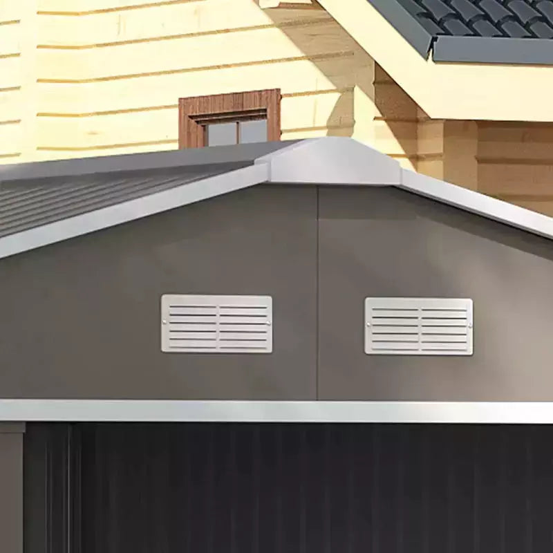 Close-up of two white louvred vents set into the light grey shed gable