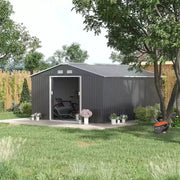 Dark grey metal garden shed on a patio with sliding doors open and a mower nearby