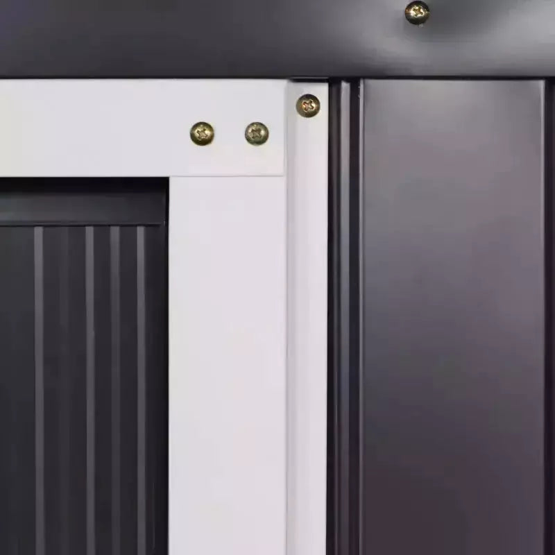 Close-up of the dark grey corrugated wall panels beside the white door frame