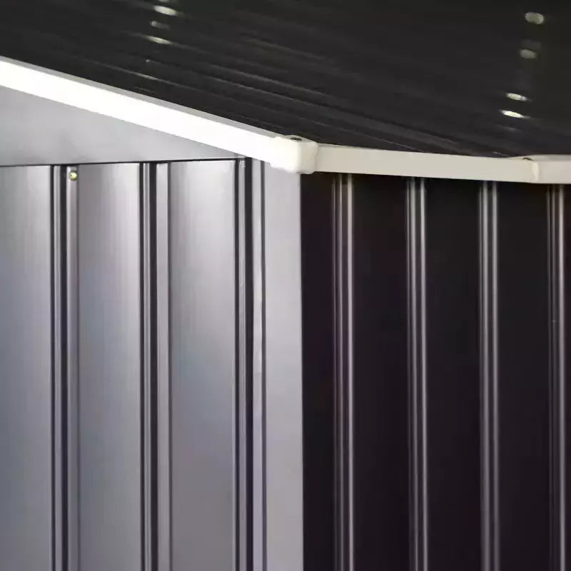 Close-up of the ribbed dark grey steel panels running up to the roof line